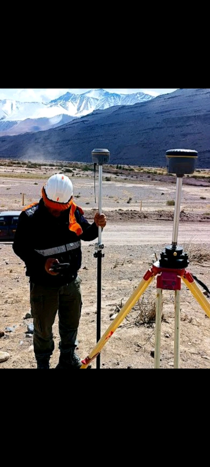 Topógrafo trabajando en terreno con equipo de medición