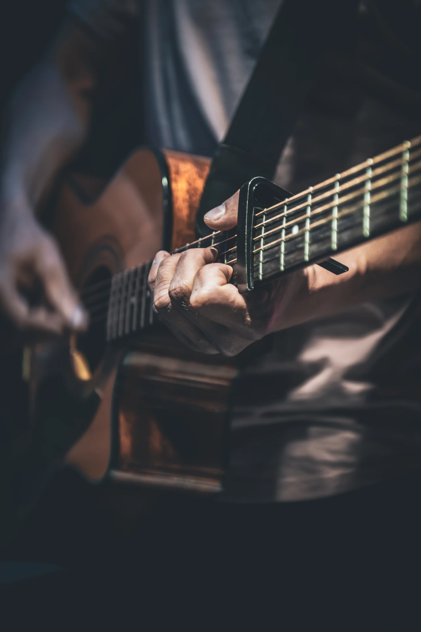 man-plays-acoustic-guitar-closeup.webp