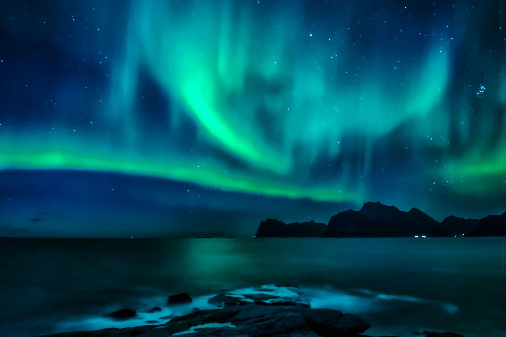 Geomagnetic solar storm reflections along the rugged western coastal shoreline.